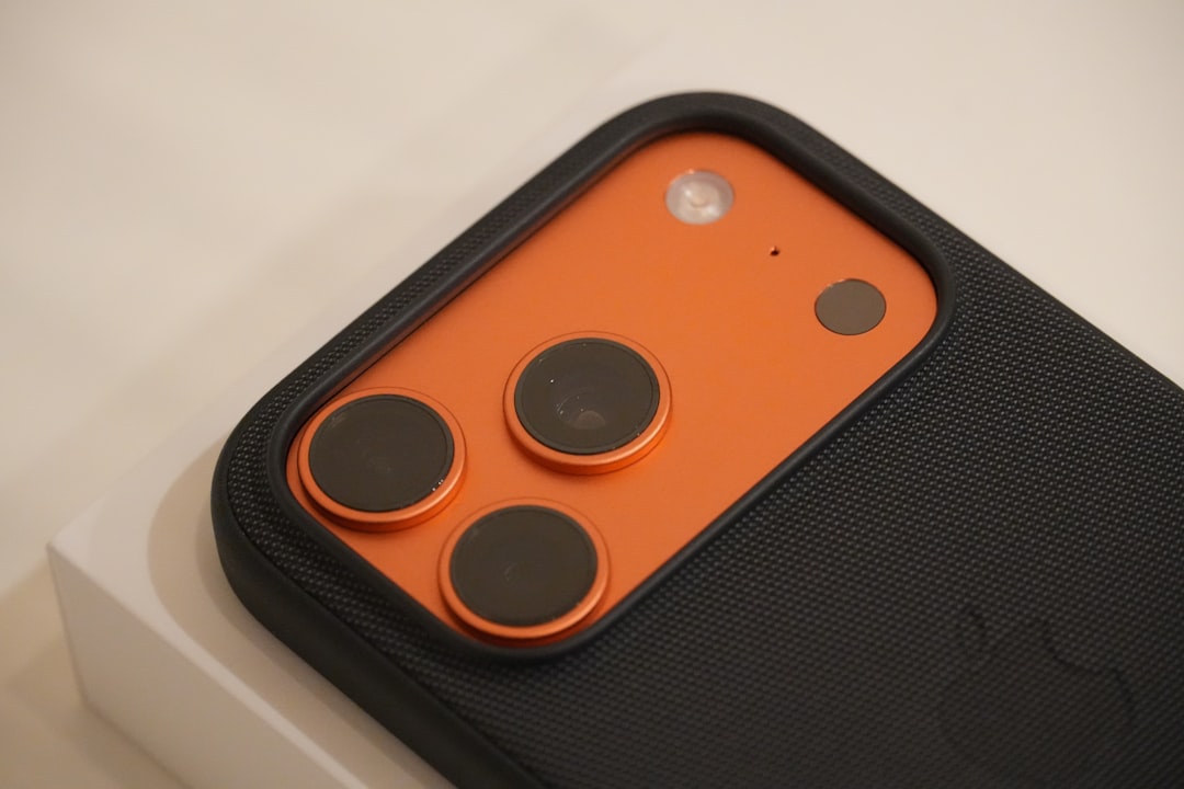 Close-up of a smartphone camera with orange accent.